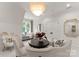 Bright living room featuring plush seating, stylish decor, and a modern chandelier at 8500 Longview Club Dr, Waxhaw, NC 28173