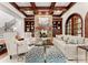 Spacious living room with stone fireplace, built-in bookshelves, and coffered wood ceilings at 8500 Longview Club Dr, Waxhaw, NC 28173