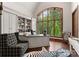 Bright office features custom built-ins, a zebra rug, and a large window with wooded views at 8500 Longview Club Dr, Waxhaw, NC 28173