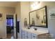 Well-lit bathroom featuring a modern vanity and an open doorway to the main bedroom at 858 Oak Manor Se Dr, Concord, NC 28025