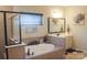 Bathroom with a standalone tub, tiled shower, and double sink vanity with framed mirror at 858 Oak Manor Se Dr, Concord, NC 28025