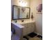 Bathroom vanity featuring white cabinetry, sleek fixtures, and a framed mirror at 858 Oak Manor Se Dr, Concord, NC 28025