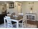 A bright dining area features a wooden table, white chairs, and stylish decor accents on a plush gray rug at 858 Oak Manor Se Dr, Concord, NC 28025