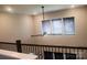 Upstairs hallway featuring a ceiling fan and natural lighting from three windows at 858 Oak Manor Se Dr, Concord, NC 28025