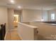 Second floor hallway with neutral paint and a partial view of the living room at 858 Oak Manor Se Dr, Concord, NC 28025