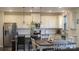 Eat-in kitchen featuring granite counters, white cabinets, and stainless appliances at 858 Oak Manor Se Dr, Concord, NC 28025