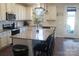 Well-lit kitchen featuring granite countertops, white cabinets, and an island with bar seating at 858 Oak Manor Se Dr, Concord, NC 28025