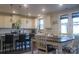 Inviting eat-in kitchen with white cabinets, an island with bar seating, and adjacent dining area at 858 Oak Manor Se Dr, Concord, NC 28025