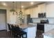 Modern kitchen with granite countertops, stainless steel appliances, and a center island at 858 Oak Manor Se Dr, Concord, NC 28025