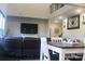 Spacious living room with a dark brown leather sectional sofa and large television with lots of natural light at 858 Oak Manor Se Dr, Concord, NC 28025