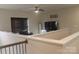 Upstairs loft area features a ceiling fan, a television, and a comfortable black leather chair at 858 Oak Manor Se Dr, Concord, NC 28025