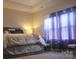 Comfortable bedroom with tray ceilings, large windows with light-blocking shades, and a cozy carpet at 858 Oak Manor Se Dr, Concord, NC 28025