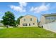Expansive backyard featuring lush green grass, mature trees, and a classic two-story home with ample natural light at 8604 Rockmoor Ridge Rd, Charlotte, NC 28215