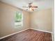 Bright bedroom with wood-look floors and a window at 8604 Rockmoor Ridge Rd, Charlotte, NC 28215