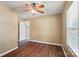 Bedroom with wood-look floors, baseboards, and an open doorway at 8604 Rockmoor Ridge Rd, Charlotte, NC 28215