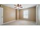 Neutral carpeted bedroom featuring a ceiling fan, natural light, and a fresh, neutral color scheme at 8604 Rockmoor Ridge Rd, Charlotte, NC 28215