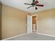 Bedroom features neutral walls, carpet, ceiling fan, and white trim at 8604 Rockmoor Ridge Rd, Charlotte, NC 28215