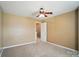 Neutral carpeted bedroom featuring a ceiling fan, natural light, and a fresh, neutral color scheme at 8604 Rockmoor Ridge Rd, Charlotte, NC 28215