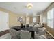 This is a virtually staged dining room featuring hardwood floors, neutral-colored walls, and a decorative chandelier at 8604 Rockmoor Ridge Rd, Charlotte, NC 28215