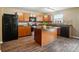 Well-equipped kitchen featuring stainless steel appliances, a black refrigerator, and a functional center island at 8604 Rockmoor Ridge Rd, Charlotte, NC 28215