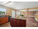 Spacious kitchen with an island, stone countertop, hardwood floors, and seamlessly connecting to the adjacent living area at 8604 Rockmoor Ridge Rd, Charlotte, NC 28215