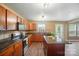 Well-lit kitchen showcasing stainless steel appliances, a center island with a stone countertop, and sleek hardwood floors at 8604 Rockmoor Ridge Rd, Charlotte, NC 28215