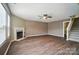 Spacious living room features a fireplace, ceiling fan, and wood-look flooring at 8604 Rockmoor Ridge Rd, Charlotte, NC 28215