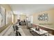 This is a virtually staged living room with hardwood floors, neutral-colored walls, and an open dining space at 8604 Rockmoor Ridge Rd, Charlotte, NC 28215
