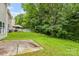 Spacious backyard featuring a patio, gazebo, lush lawn, and mature trees at 9236 Clifton Meadow Dr, Matthews, NC 28105