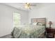 Bright bedroom with a decorative bedspread, ceiling fan, and natural light from the window at 9236 Clifton Meadow Dr, Matthews, NC 28105