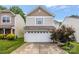 Home exterior featuring a two-car garage, neutral siding, and beautiful landscaping at 9236 Clifton Meadow Dr, Matthews, NC 28105
