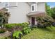 Charming home entrance with a lush garden and inviting front porch bench at 9236 Clifton Meadow Dr, Matthews, NC 28105