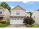 Charming two-story home with a white garage door and manicured landscaping at 9236 Clifton Meadow Dr, Matthews, NC 28105