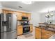 Well-equipped kitchen featuring stainless steel appliances, granite countertops and light wood cabinets at 9236 Clifton Meadow Dr, Matthews, NC 28105