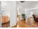Open-concept living space featuring hardwood floors, bathroom, and easy access to the kitchen at 9236 Clifton Meadow Dr, Matthews, NC 28105