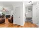 Bright living room with hardwood floors, fireplace, and comfortable leather furniture at 9236 Clifton Meadow Dr, Matthews, NC 28105