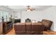 Bright living room with hardwood floors, fireplace, and comfortable brown leather seating at 9236 Clifton Meadow Dr, Matthews, NC 28105