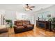 Inviting living room featuring hardwood floors, ceiling fan, and stylish furnishings at 9236 Clifton Meadow Dr, Matthews, NC 28105