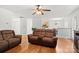 Cozy living room with hardwood floors, ceiling fan, and comfortable seating at 9236 Clifton Meadow Dr, Matthews, NC 28105