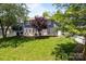 Spacious backyard with a patio, grill, trampoline, lush greenery, and privacy fence at 9412 Rosalyn Glen Rd, Cornelius, NC 28031