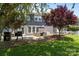 Backyard view features an outdoor patio with seating, a grill, trampoline, and mature trees at 9412 Rosalyn Glen Rd, Cornelius, NC 28031
