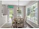 Bright breakfast nook with a round table, lots of windows, and a view of the backyard at 9412 Rosalyn Glen Rd, Cornelius, NC 28031