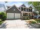 Charming two-story home with a two-car garage, inviting front porch, and classic architectural details at 9412 Rosalyn Glen Rd, Cornelius, NC 28031