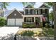Charming two-story home with a welcoming front porch, manicured lawn, and a two car garage at 9412 Rosalyn Glen Rd, Cornelius, NC 28031