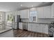 An open kitchen offers stainless steel appliances, hardwood floors, and a view from the window at 9412 Rosalyn Glen Rd, Cornelius, NC 28031