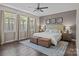 A spacious main bedroom features hardwood floors and a stylish upholstered headboard at 9412 Rosalyn Glen Rd, Cornelius, NC 28031