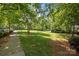 A lush park with a paved path offers serene green space for recreation and relaxation at 9412 Rosalyn Glen Rd, Cornelius, NC 28031