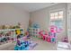 Bright playroom with toys, a table and chairs, and a view of the outside through the window at 9412 Rosalyn Glen Rd, Cornelius, NC 28031