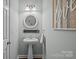 Stylish powder room with a pedestal sink, decorative mirror and modern lighting fixtures at 9412 Rosalyn Glen Rd, Cornelius, NC 28031