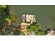Aerial view of a boat dock with a boat, outdoor seating, and stairs on a serene lake at 10043 Tepa Pl, Tega Cay, SC 29708